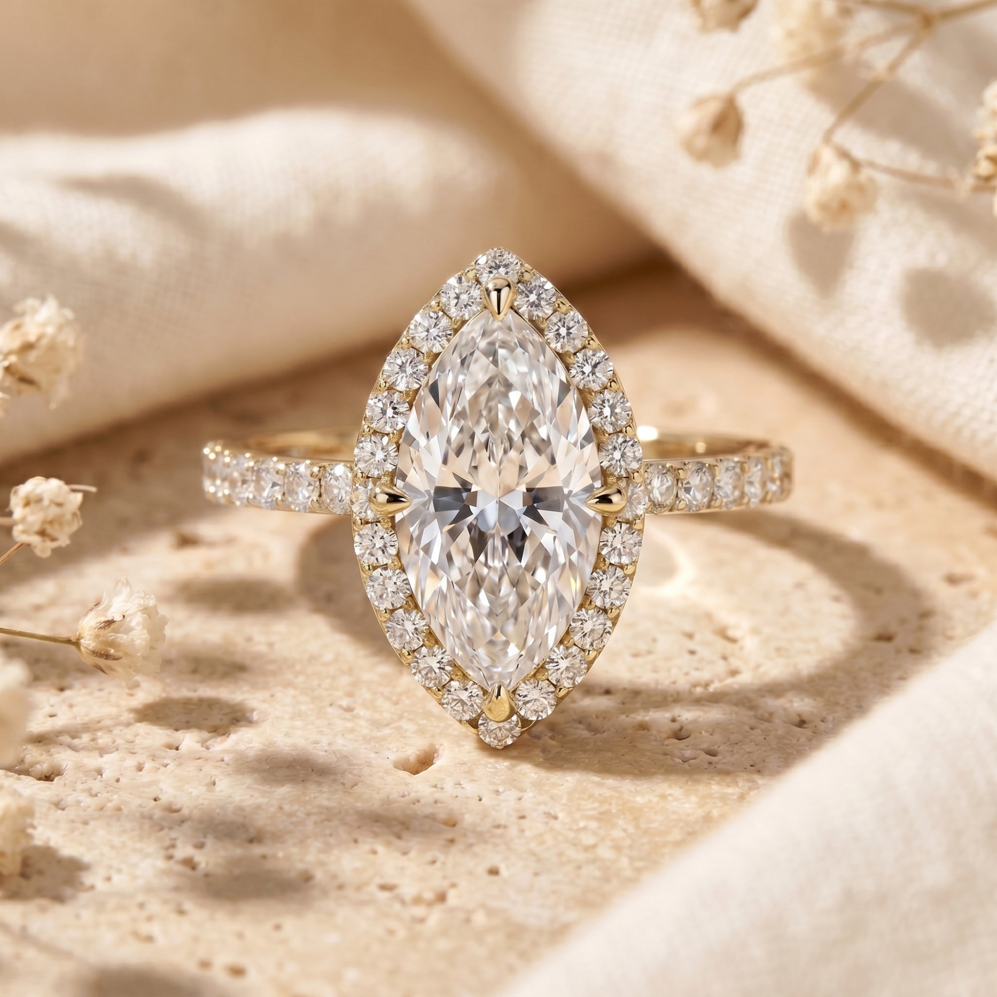 Yellow gold marquise cut moissanite halo ring shown in a lifestyle setting.