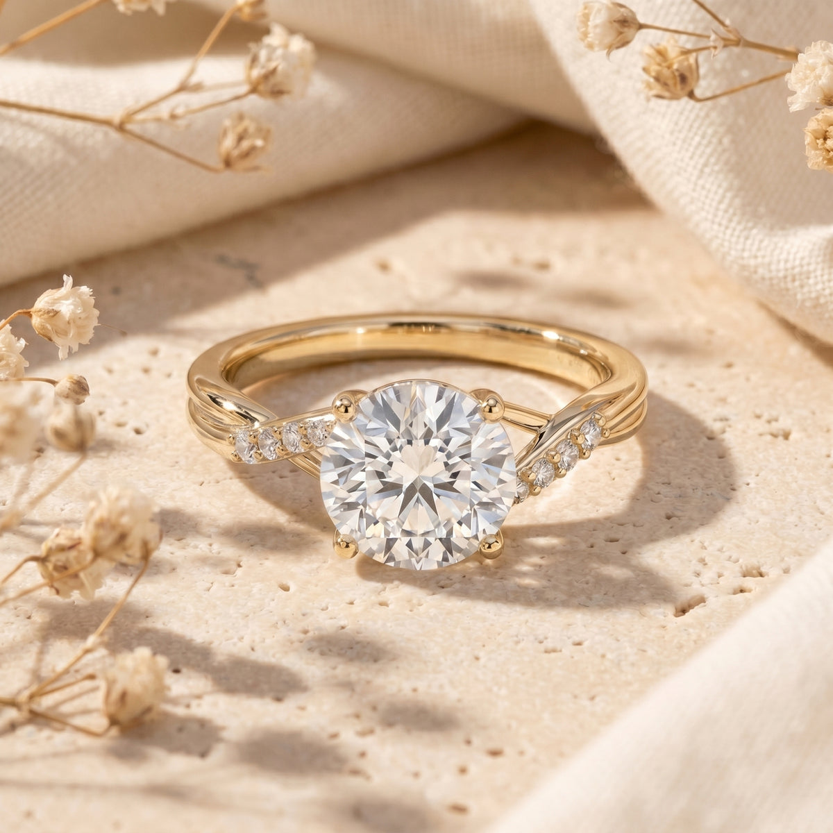 Round cut moissanite promise ring in yellow gold with twisting band on stone surface.