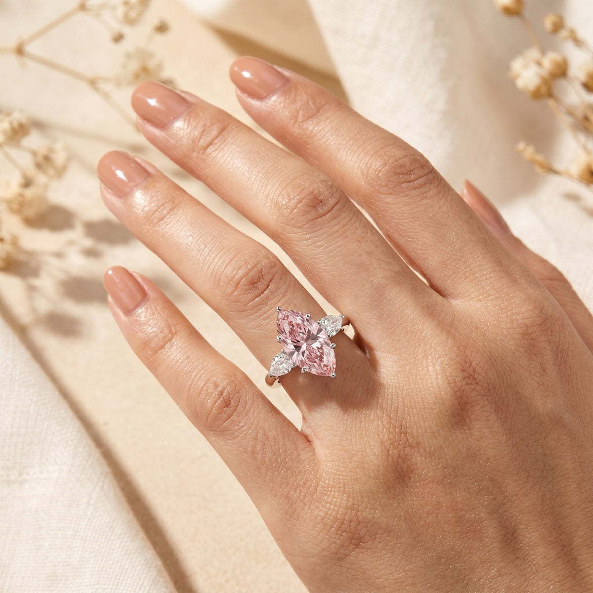 Marquise pink moissanite silver ring on a finger showing the 2-carat scale and stone brilliance.