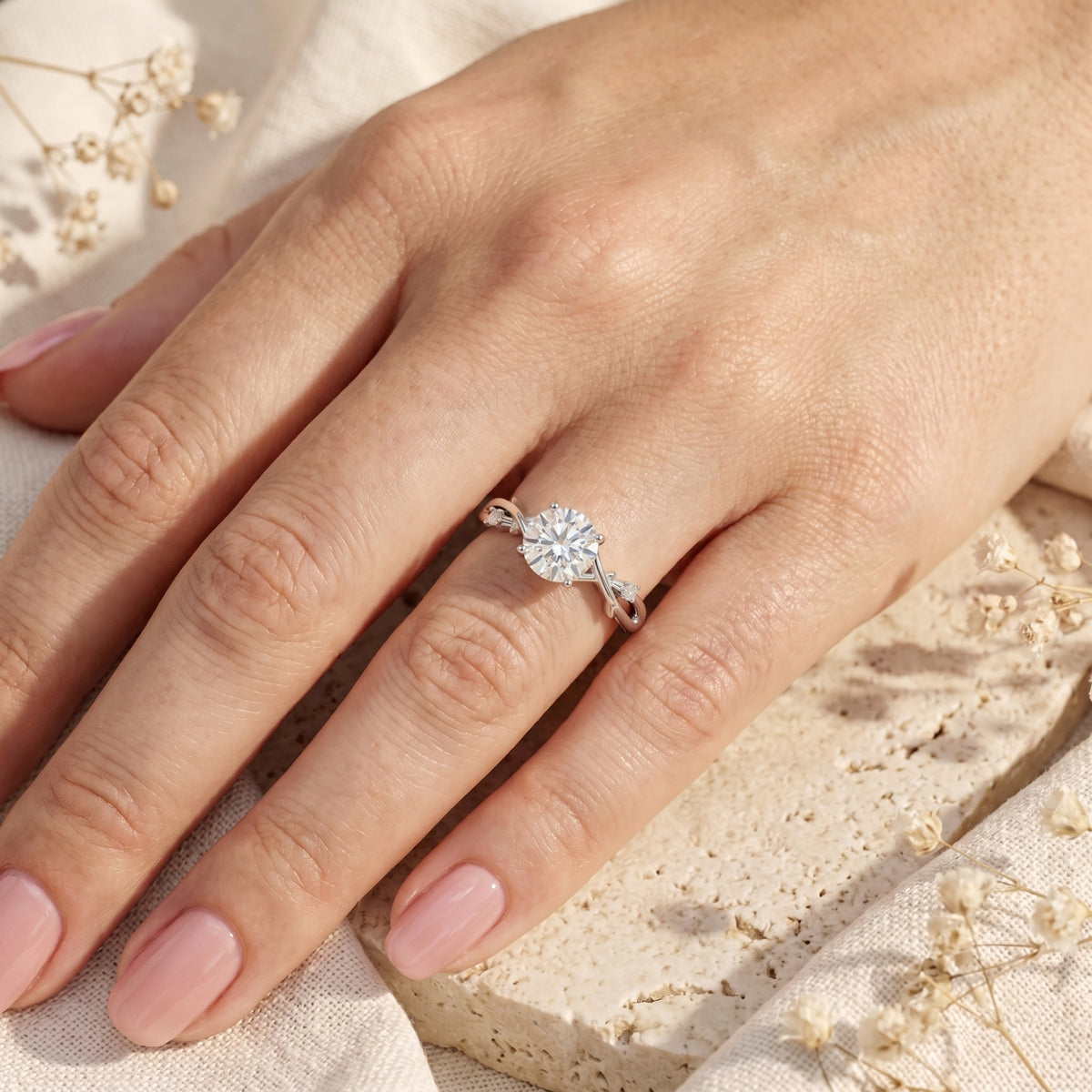 Woman wearing the Sylvella 2ct round moissanite engagement ring in sterling silver on her ring finger.