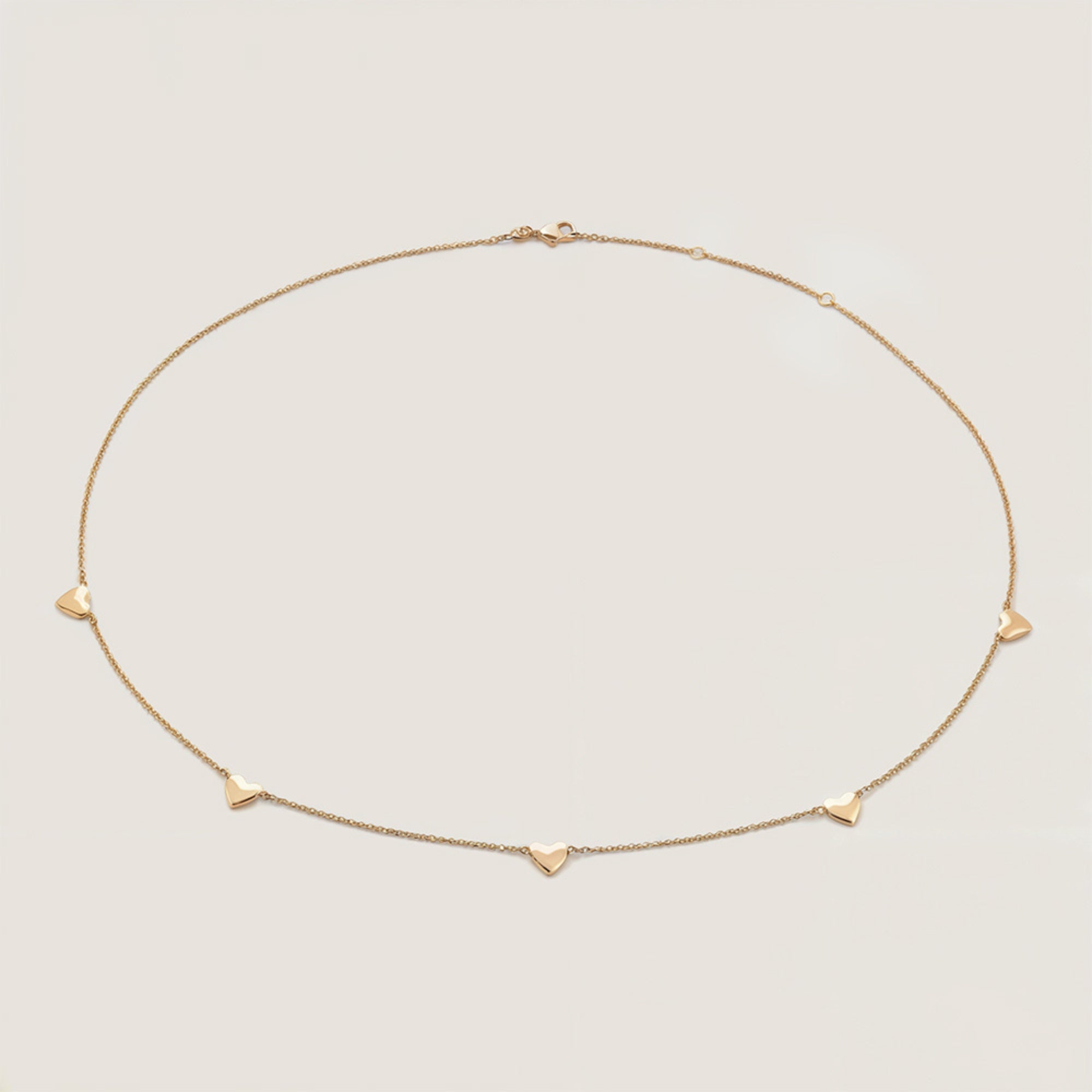 Solid gold heart chain necklace featuring 6mm charms on an adjustable chain