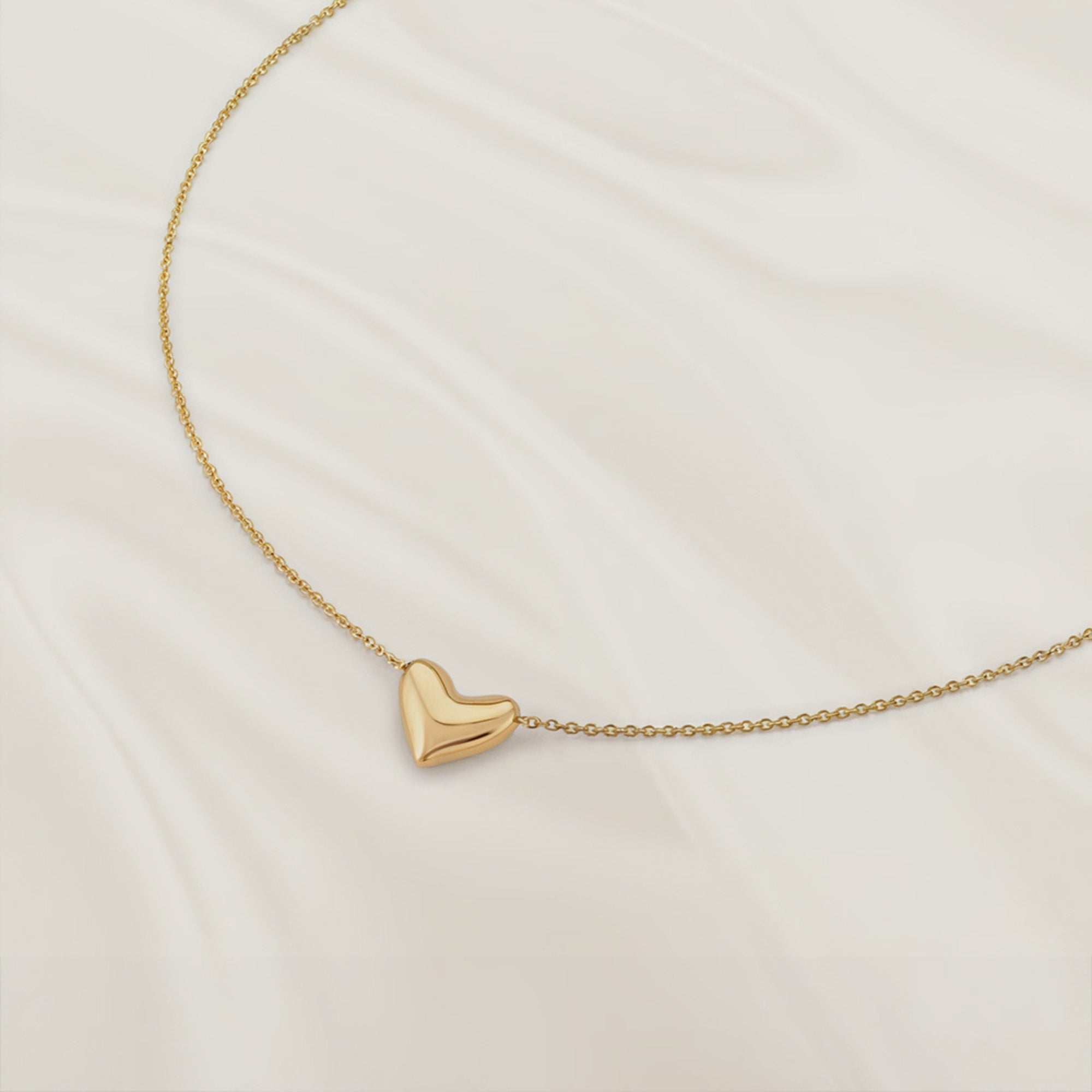 Adjustable solid gold heart necklace with an 11mm by 12mm pendant.