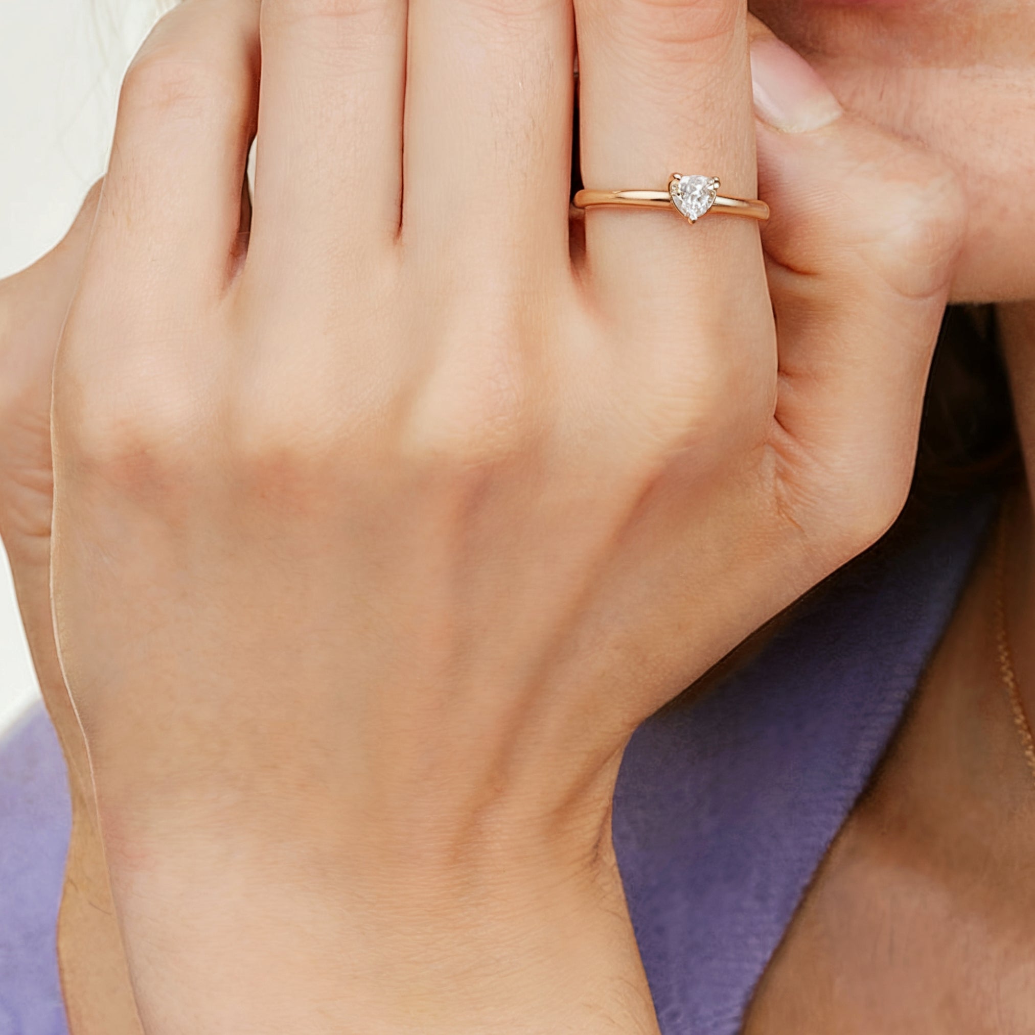 A 14K solid gold ring showcasing a 0.5 carat heart-cut Moissanite or Lab Grown Diamond.