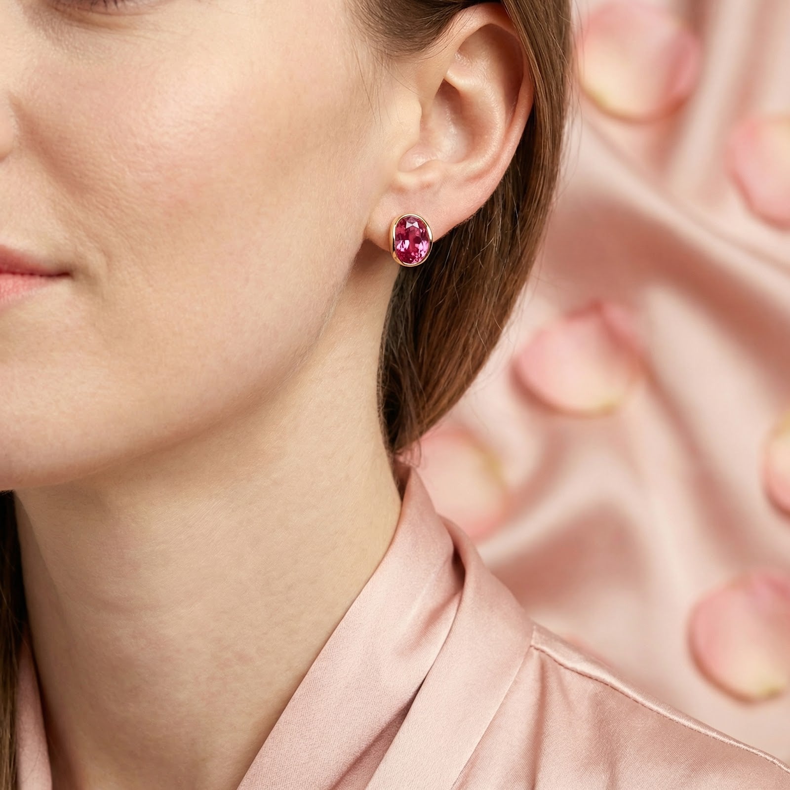 Lifestyle view of a woman wearing the Isolara pink tourmaline drop earrings in 18K gold plating.