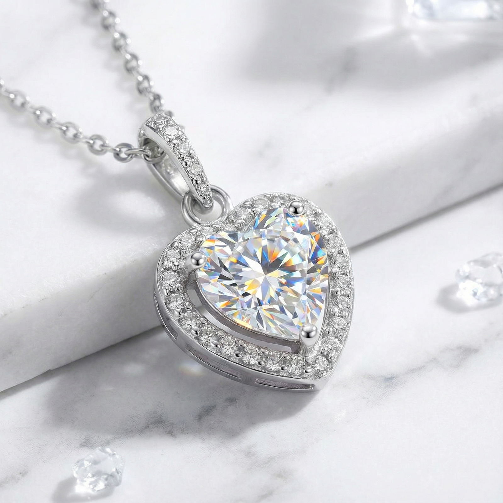 Heart-cut simulated diamond necklace in S925 sterling silver halo setting on a white marble background.