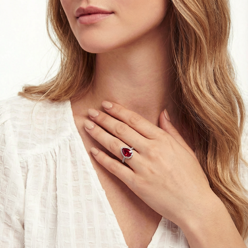 Model wearing the Lucerienne pear-cut ruby ring in sterling silver, paired with a white blouse.