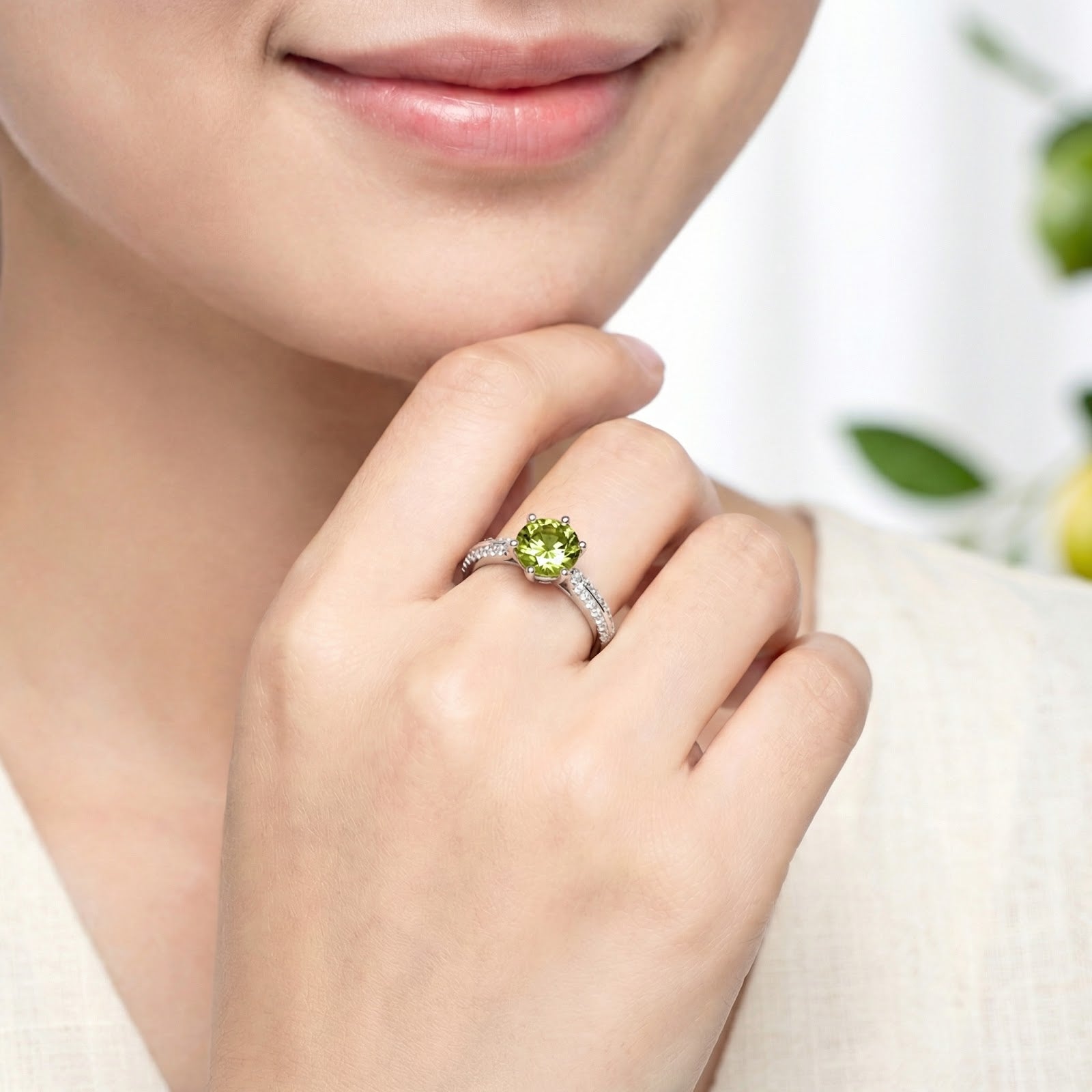 Sterling silver simulated peridot ring worn on a woman's hand, showcasing its scale and vibrant green color.