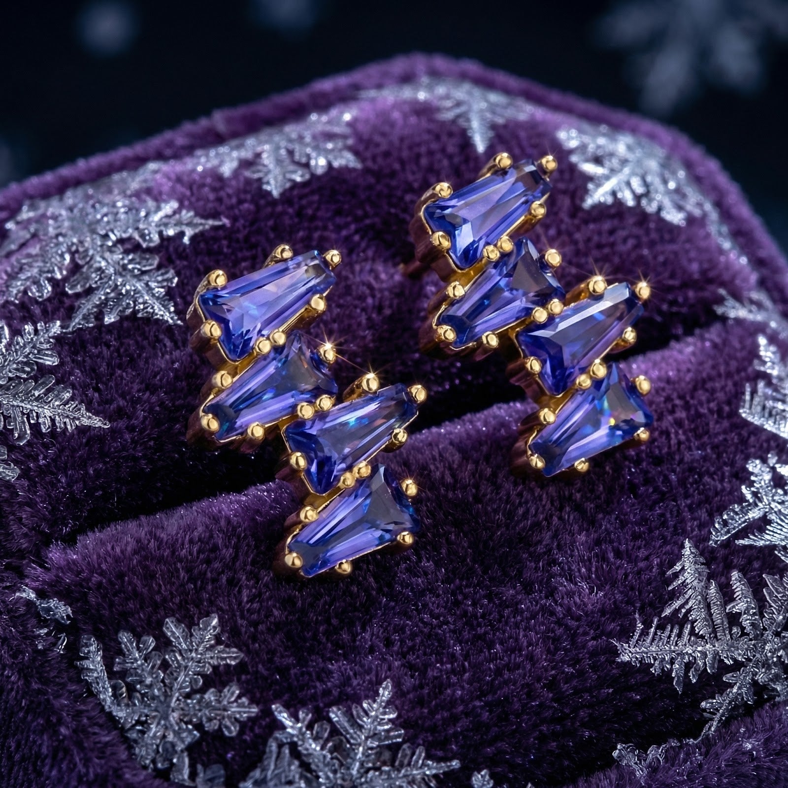 Angled macro shot of the 18K gold vermeil Neriselle cluster earrings with geometric blue-violet simulated tanzanite.