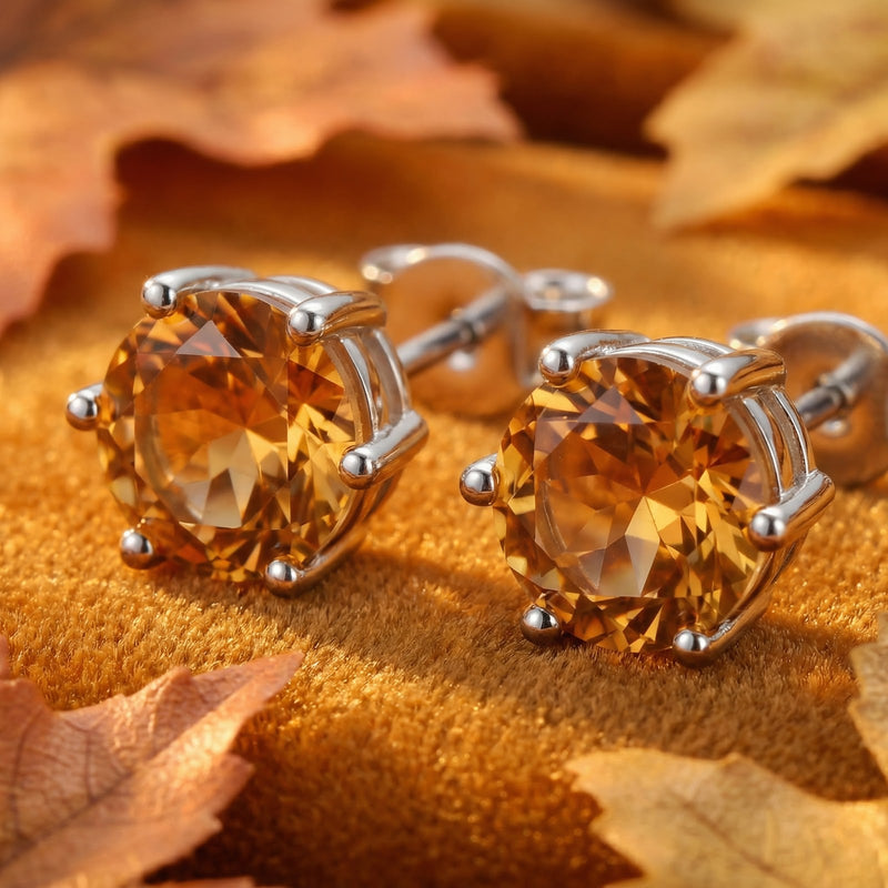 Macro view of round-cut simulated topaz earrings in sterling silver prong settings.