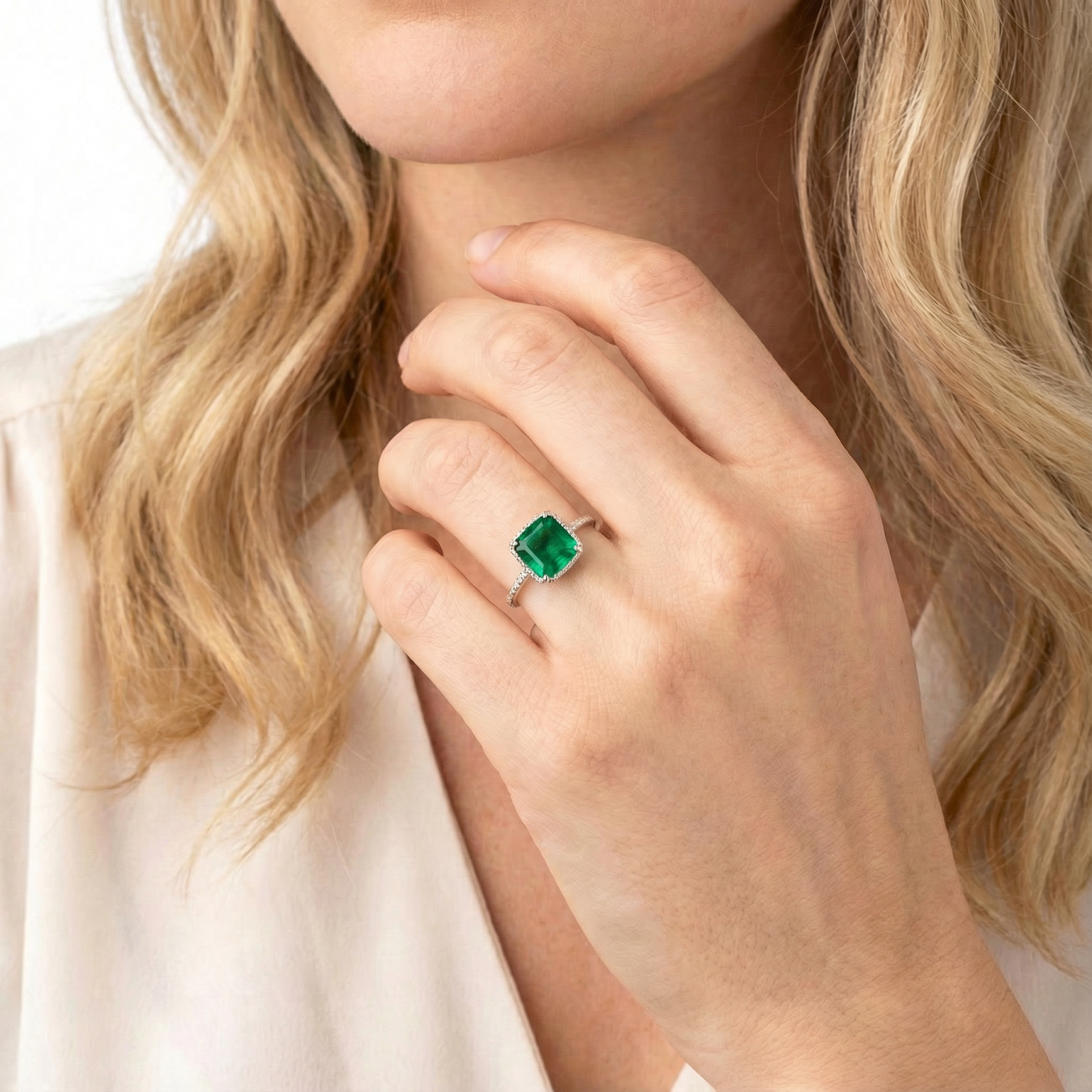 Simulated emerald sterling silver ring on a woman's finger, showcasing the May birthstone jewelry.