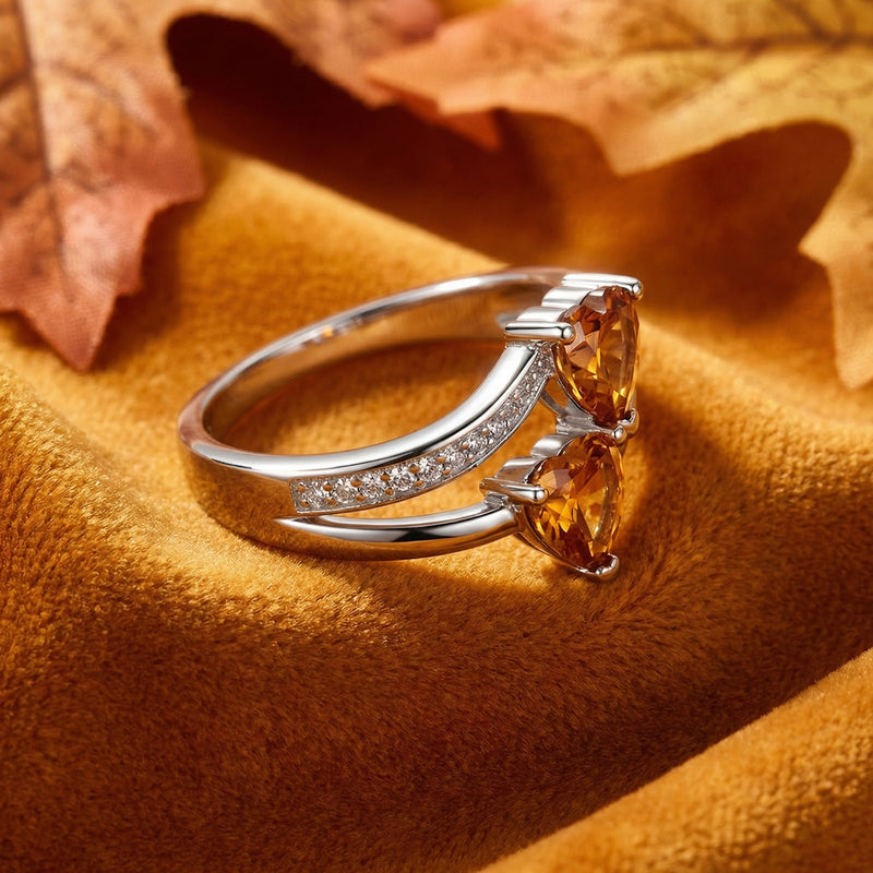 Angled side view of the Marisara heart ring in S925 sterling silver with twin honeyed simulated topaz stones.