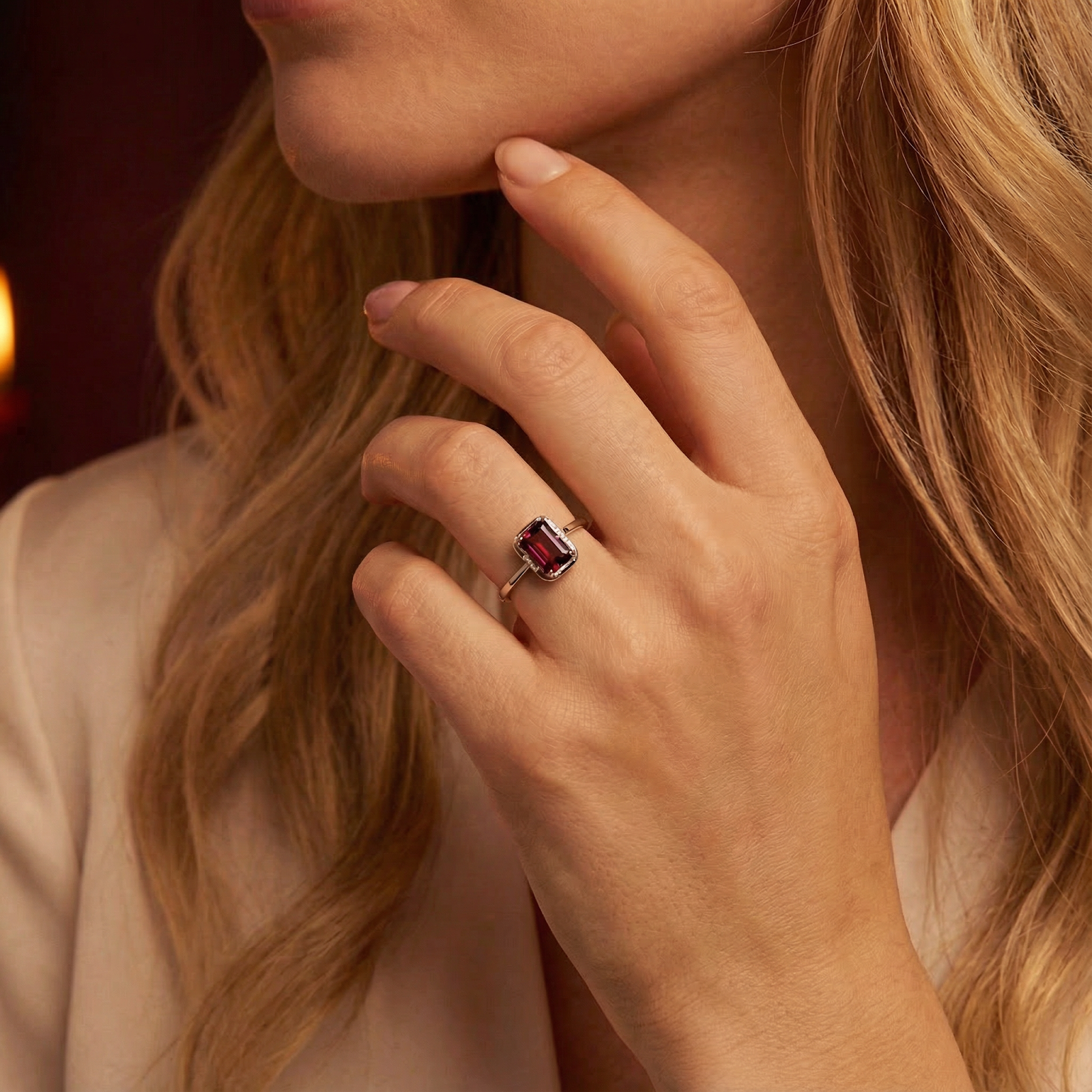 Emerald-cut simulated garnet ring in S925 sterling silver worn by a model in a warm, elegant lifestyle setting.