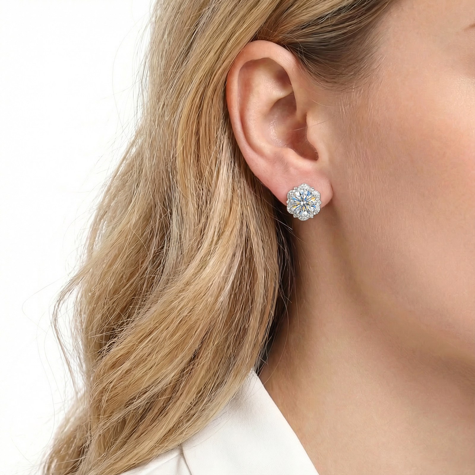 Close-up of a woman's ear wearing a silver Isolde halo stud earring with a round cut A5 zirconia.