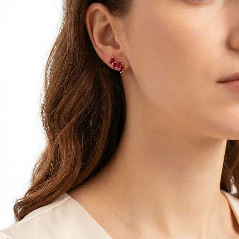Side profile of a model wearing the Rhianna Studs in 18K gold vermeil with vibrant red trillion-cut rubies.