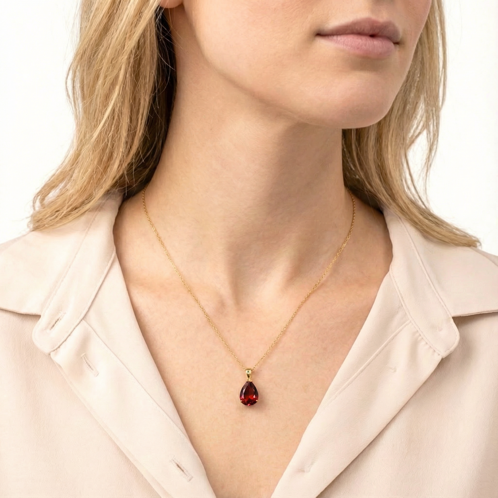 Model wearing the Seraphia Teardrop pear cut simulated garnet necklace in 18K gold vermeil.