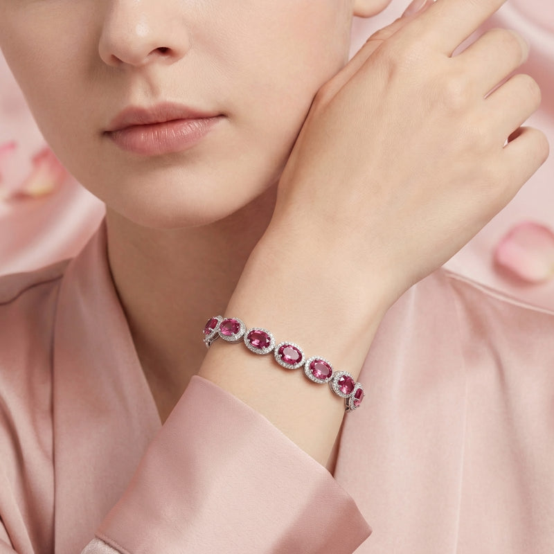 Model wearing the sterling silver Lyranise halo bracelet featuring oval-cut simulated pink tourmaline.