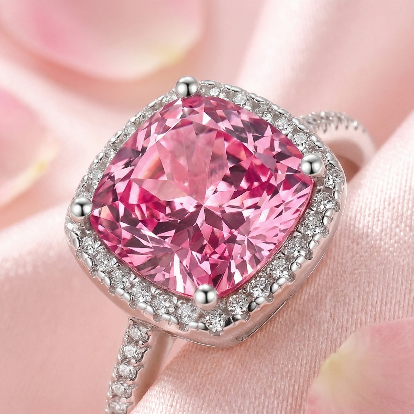 Macro view of a cushion cut simulated pink tourmaline in a sterling silver halo setting with pavé accents.