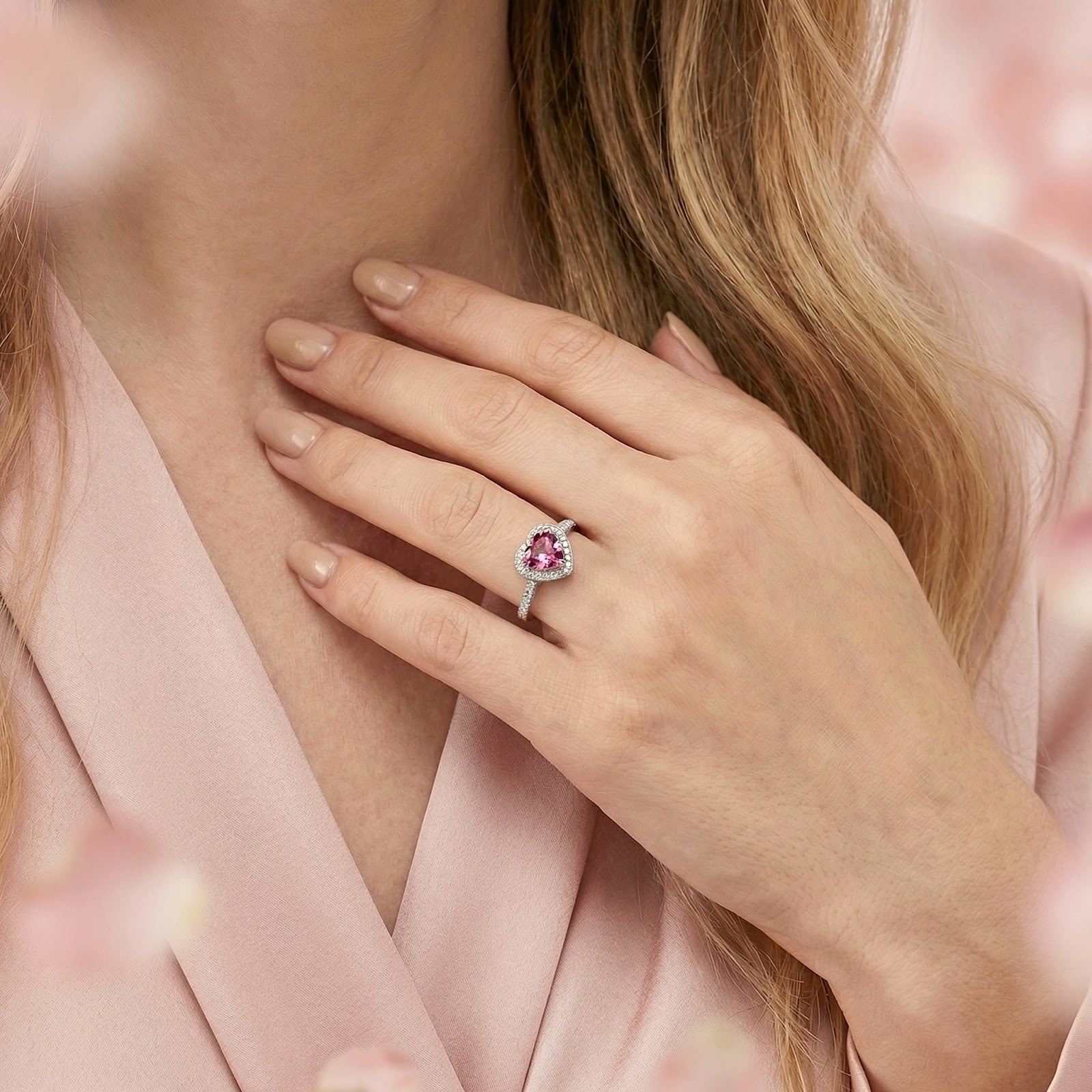 Model wearing the heart-cut simulated pink tourmaline sterling silver ring against a pink blouse.