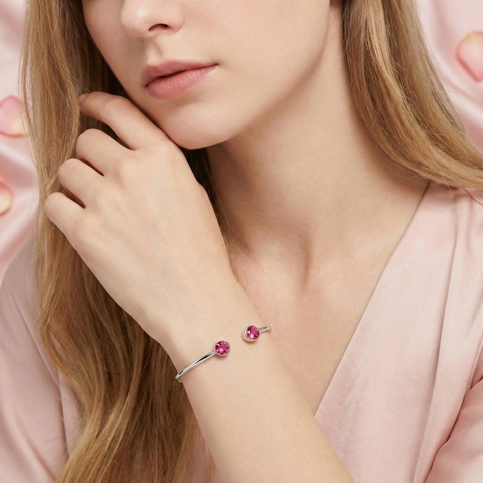 Model wearing the silver stainless steel Lyrielle cuff bracelet with pink tourmaline stones on her wrist.