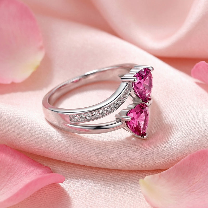 Side view of the S925 sterling silver bypass ring featuring heart-cut pink tourmaline stones and pavé accents.