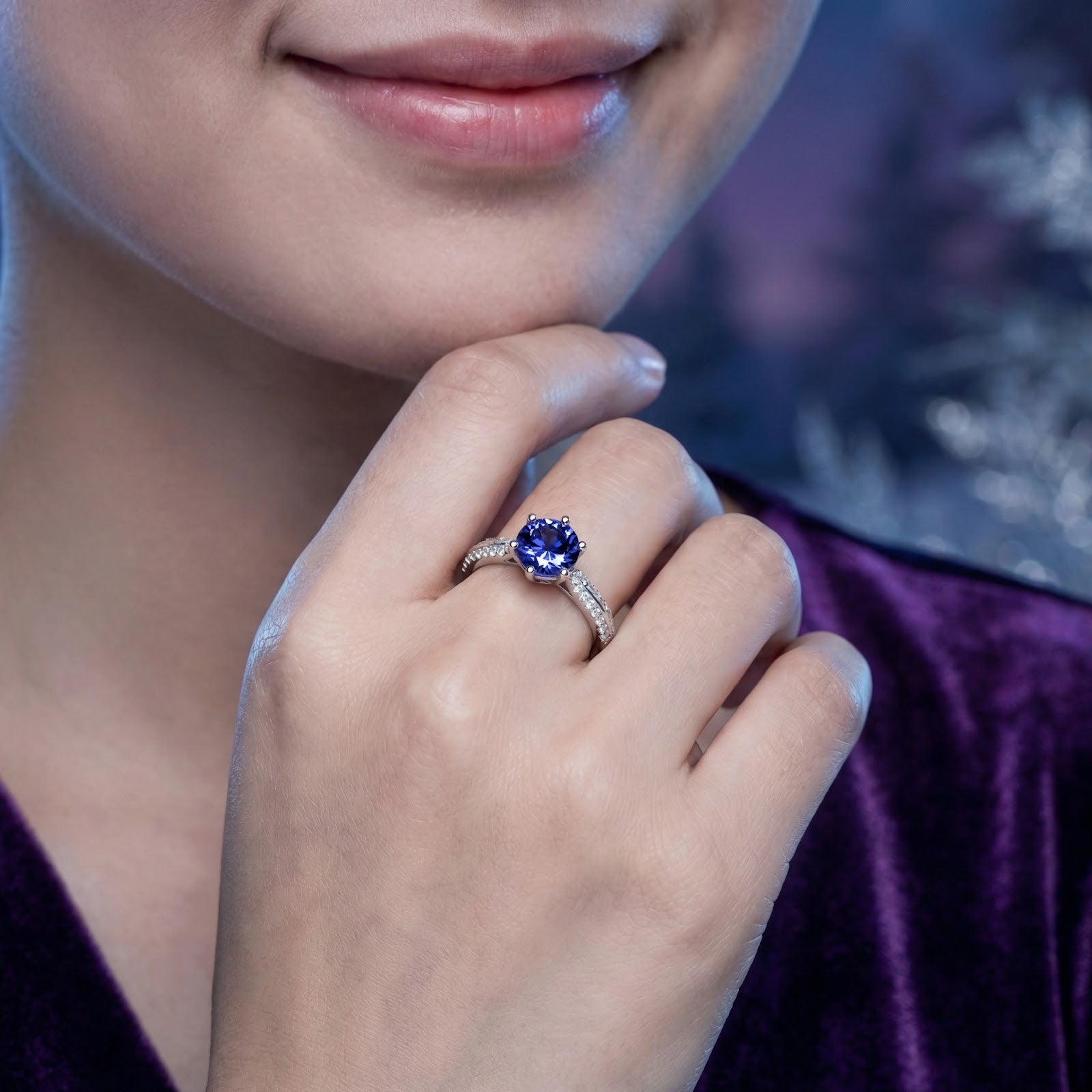 Model wearing the Elianise round simulated tanzanite solitaire ring in sterling silver on her hand.
