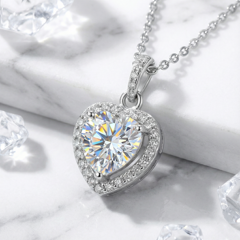 Front view of a heart-shaped simulated diamond pendant with a sparkling halo in sterling silver.
