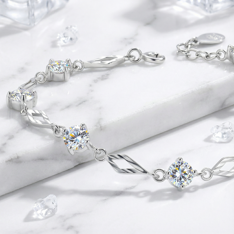 Close-up of a sterling silver station bracelet featuring round brilliant cut simulated diamonds and geometric links.