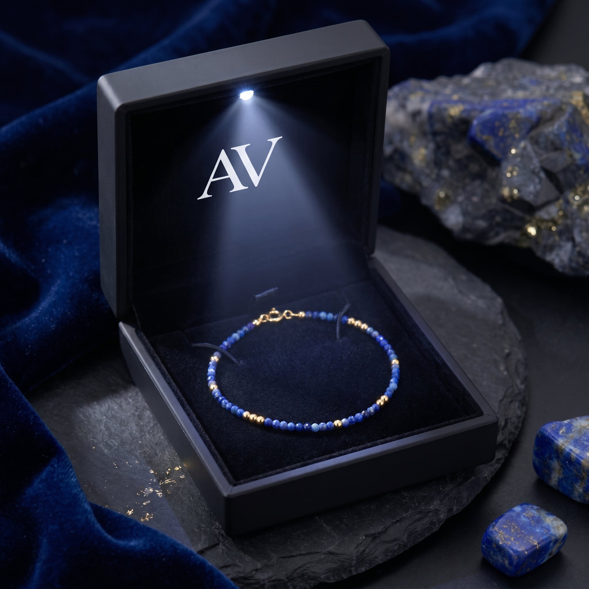 Celestial Dawn lapis lazuli bracelet presented in a luxury black light-up gift box with AV logo.