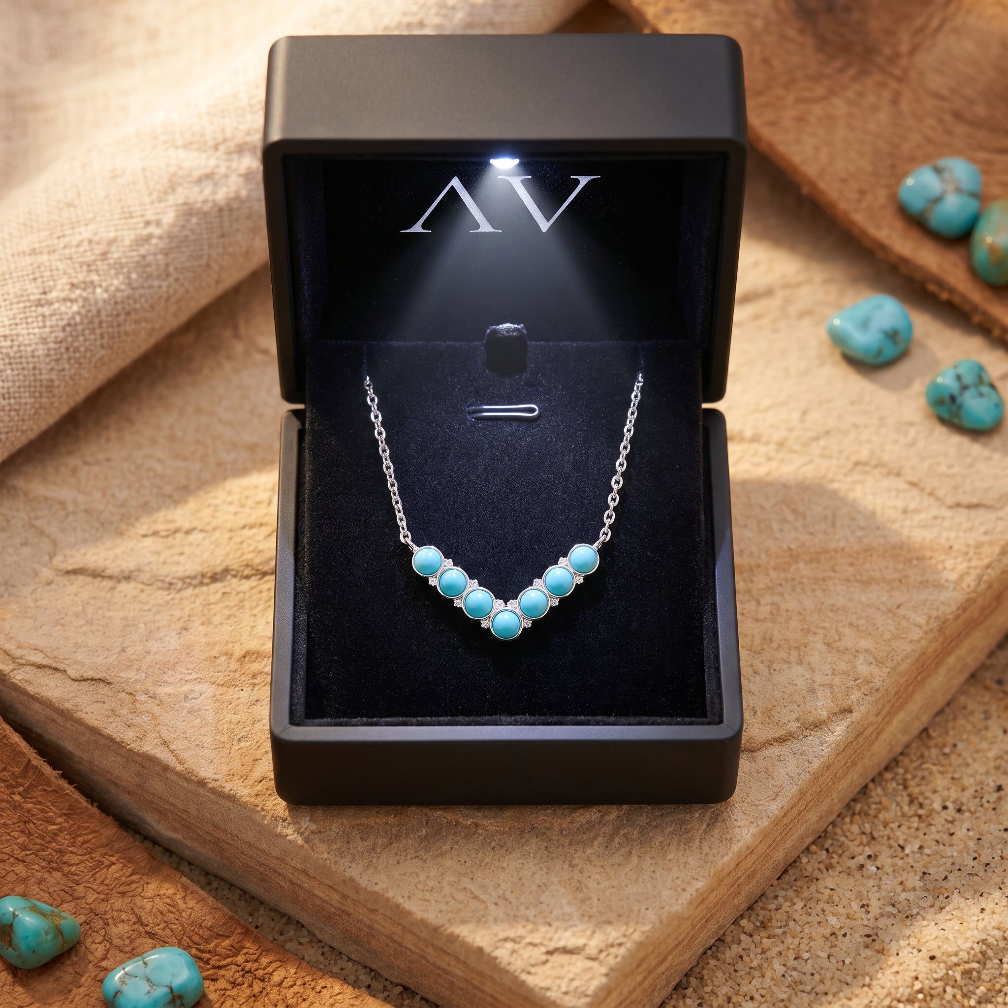 Turquoise silver necklace inside a black LED-lit jewelry presentation box.