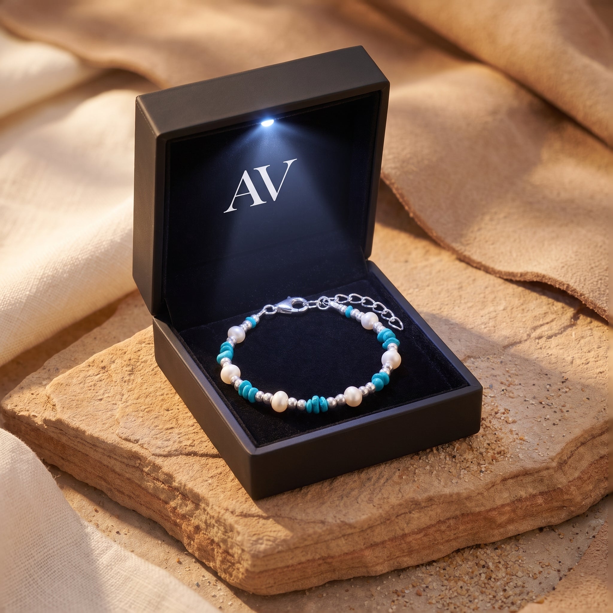 Silver turquoise and pearl bracelet in a lighted gift box.
