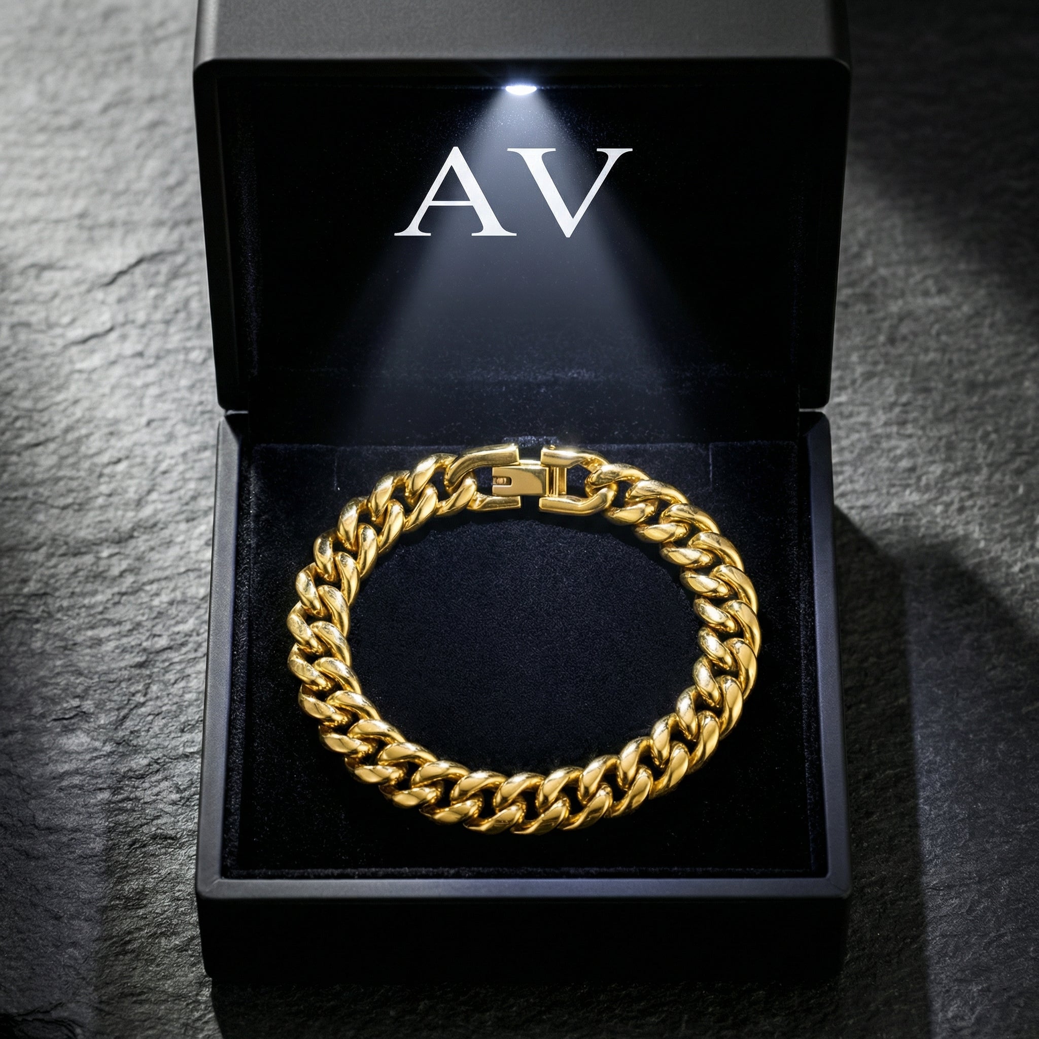 Gold stainless steel Cuban link bracelet inside a black LED-lit presentation box.