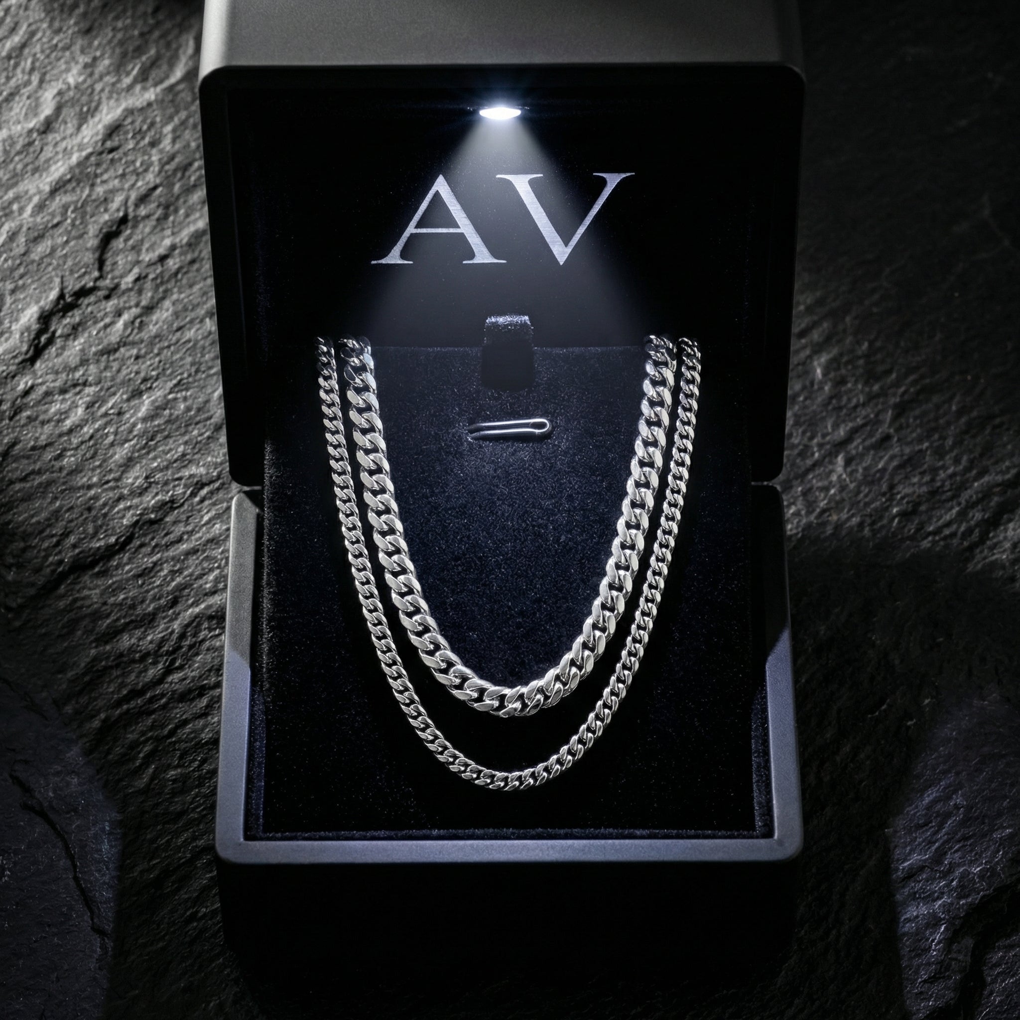 The Cuban Duo silver stainless steel stacked necklace set presented in a lighted black jewelry box with AV logo.