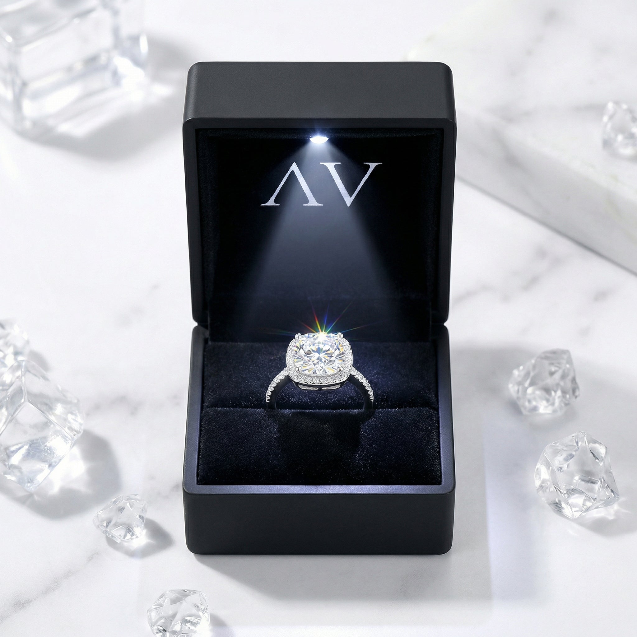 Cushion cut simulated diamond ring in a black LED-lit presentation box with AV logo.