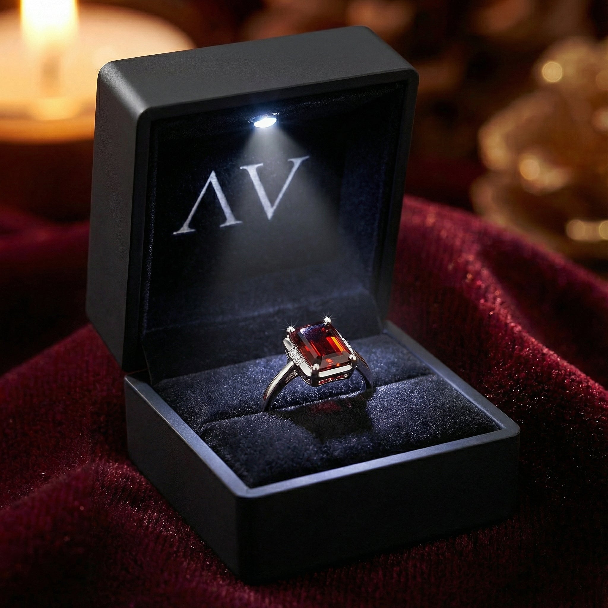 Emerald-cut simulated garnet ring in S925 sterling silver presented in a black LED-lit jewelry box on red velvet.