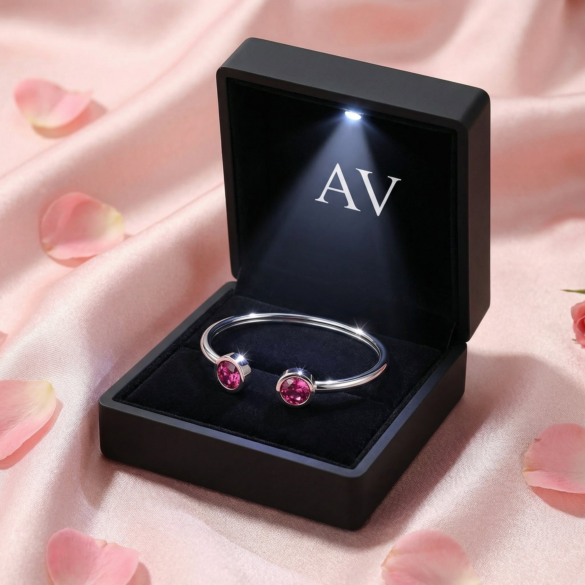 Silver stainless steel Lyrielle cuff bracelet with pink tourmaline stones in a black LED-lit gift box.