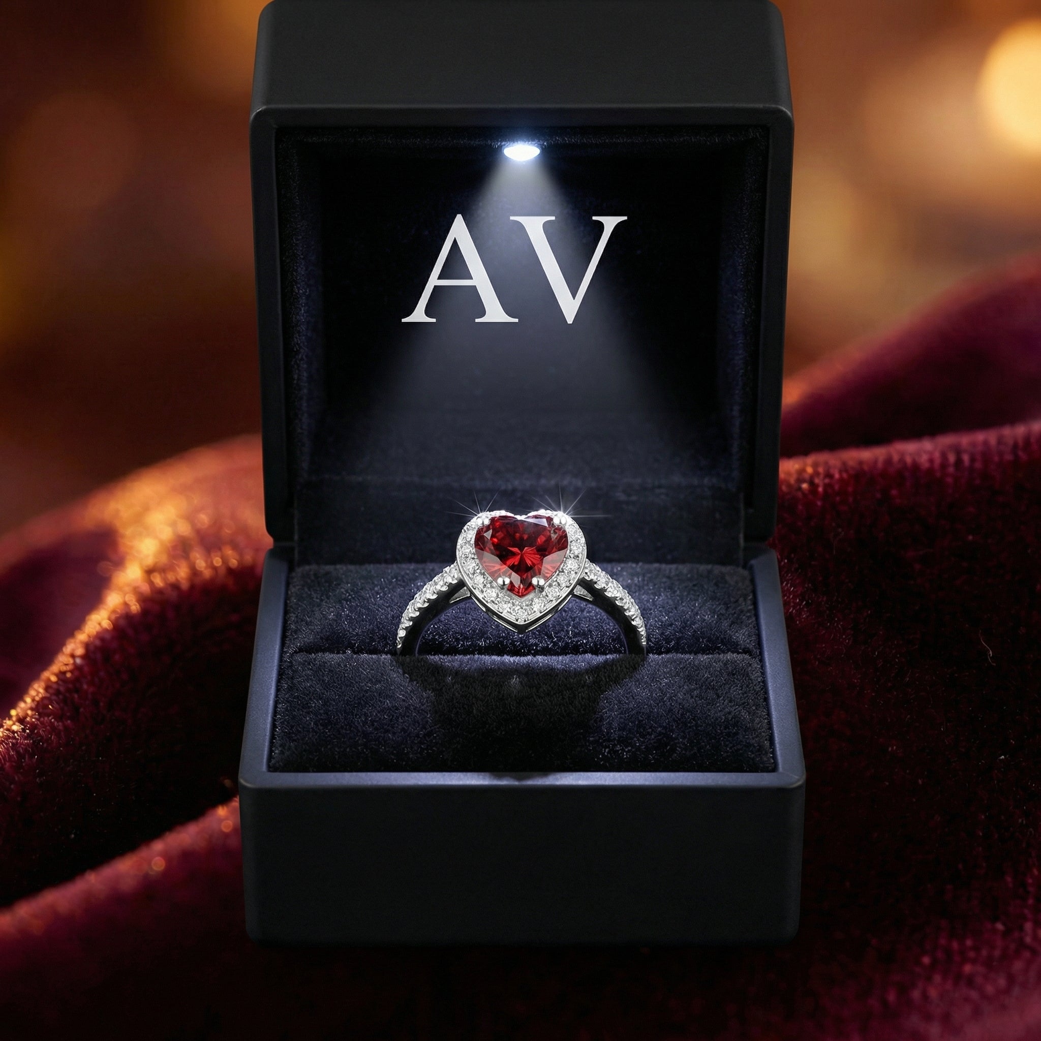 Heart-cut simulated garnet S925 sterling silver ring in a lighted black jewelry gift box.