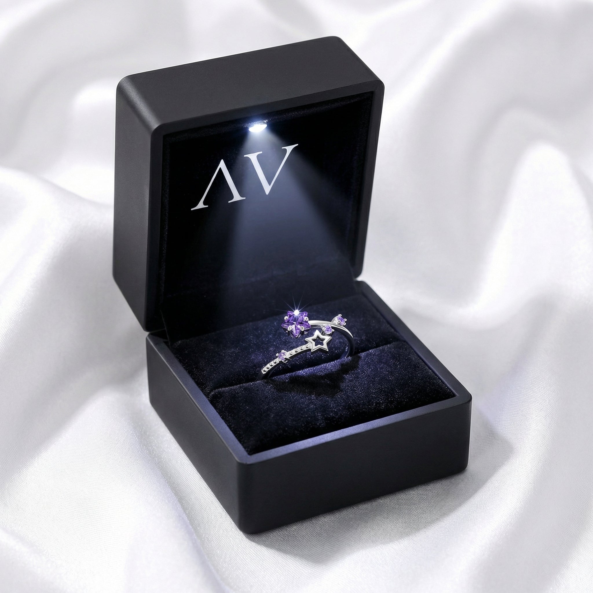 S925 sterling silver Galaxia ring with star-cut purple amethyst in a black LED-lit jewelry box.