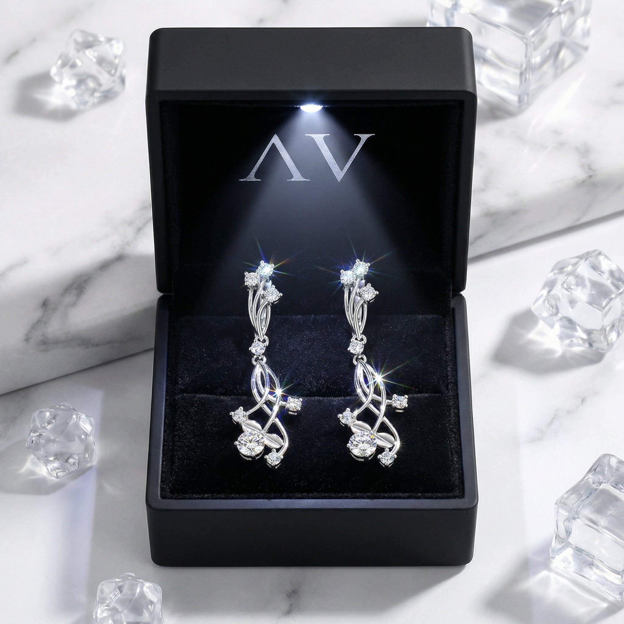 S925 sterling silver vine drop earrings with zirconia stones in a black LED-lit jewelry gift box.