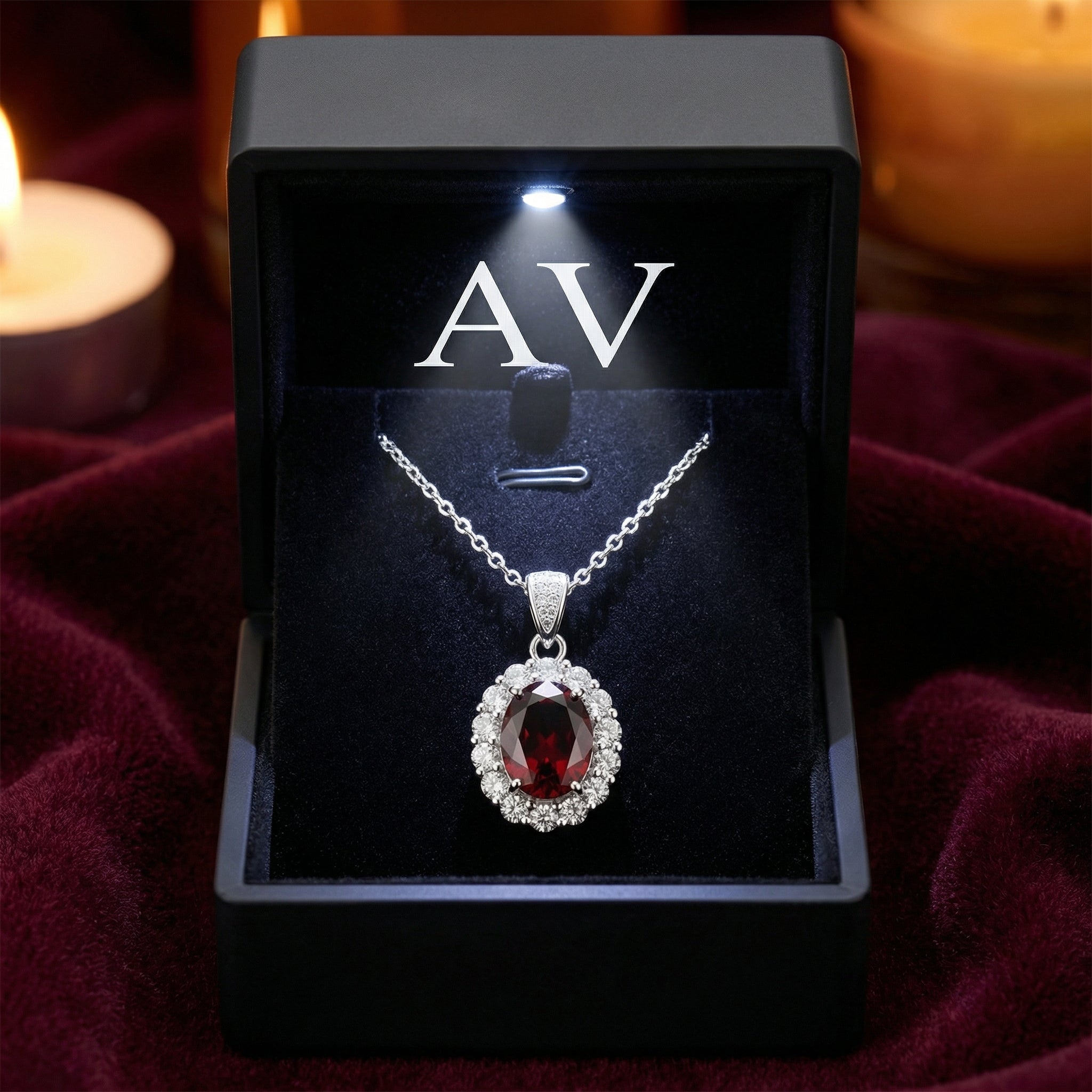Silver January birthstone garnet necklace in a lighted black AV branded gift box on red velvet.