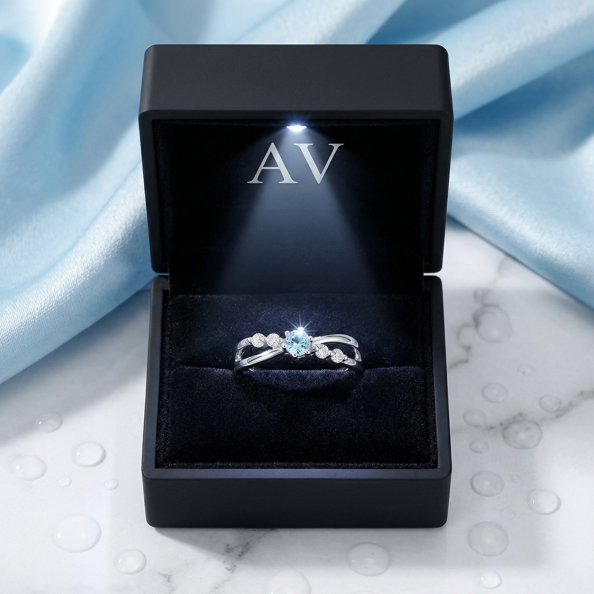 The Sylphide silver ring displayed in a premium black LED-lighted jewelry box with AV logo.