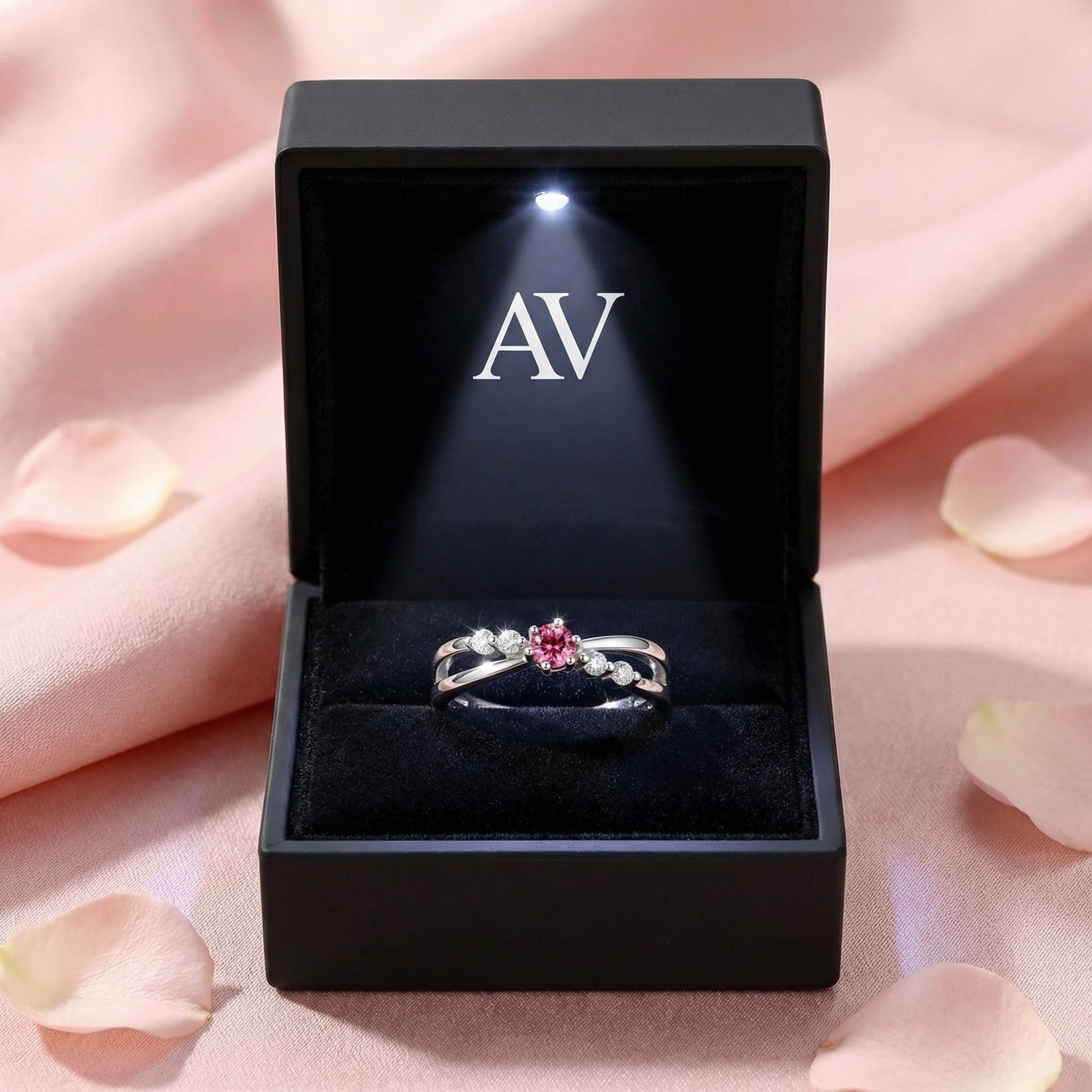 Elisanthe pink tourmaline twist ring in S925 sterling silver inside a black LED-lit jewelry presentation box.