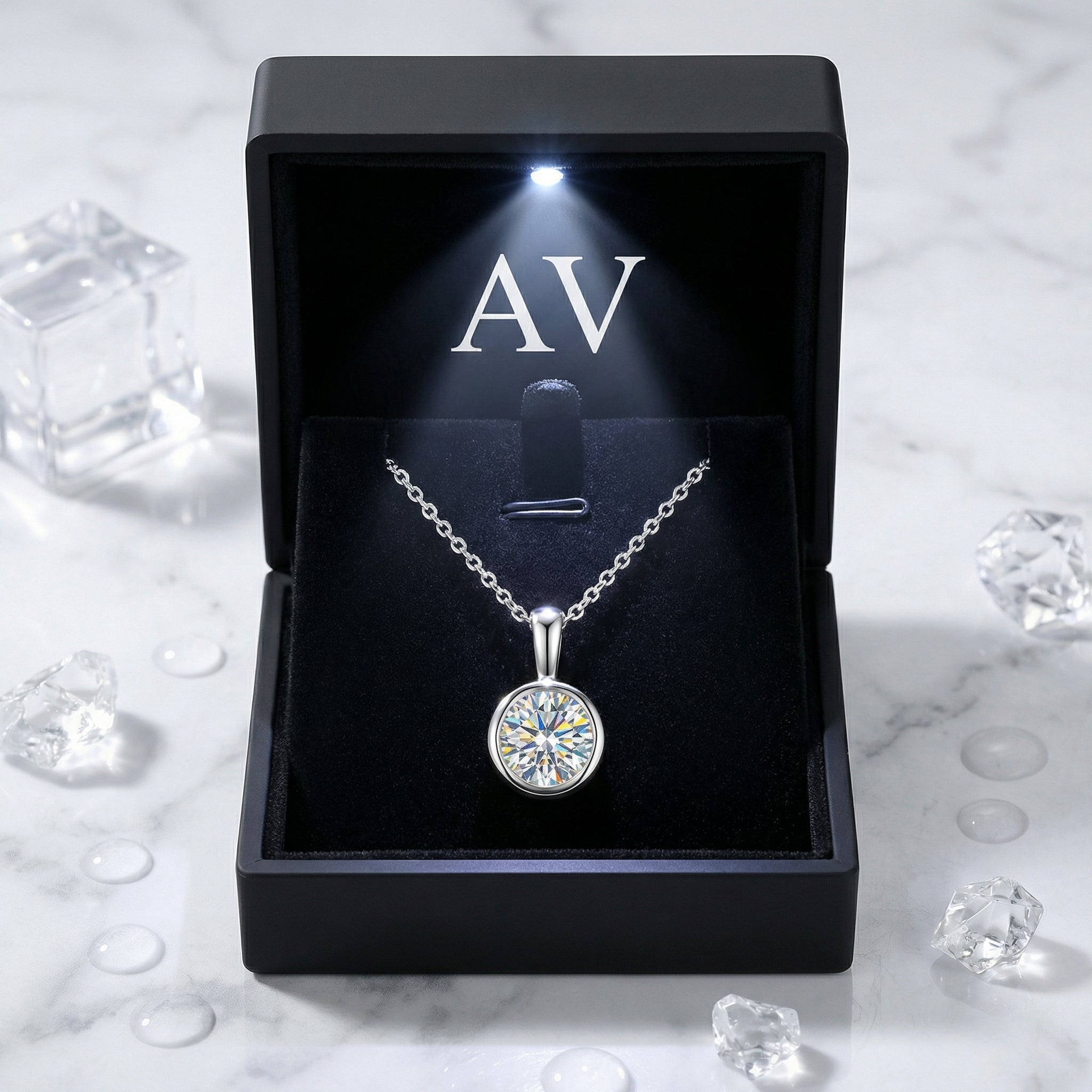 Sterling silver simulated diamond bezel necklace presented in a premium black LED-lighted gift box.