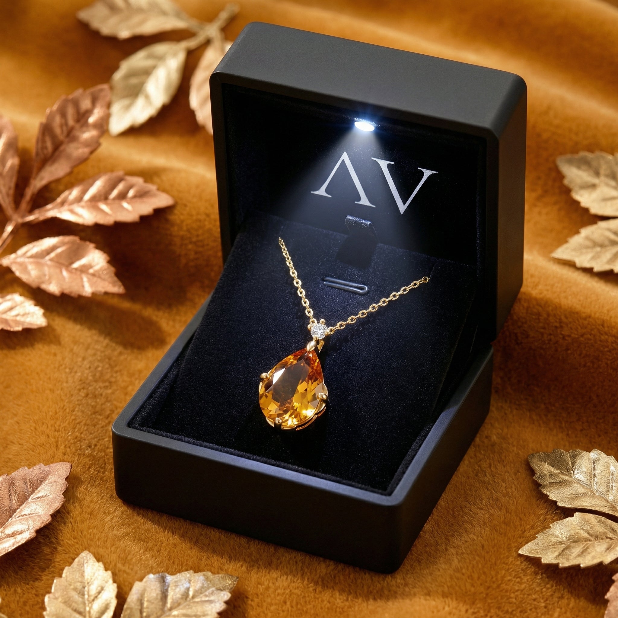 Pear-cut simulated topaz necklace in 18K gold vermeil displayed in a premium black LED-lit jewelry box.