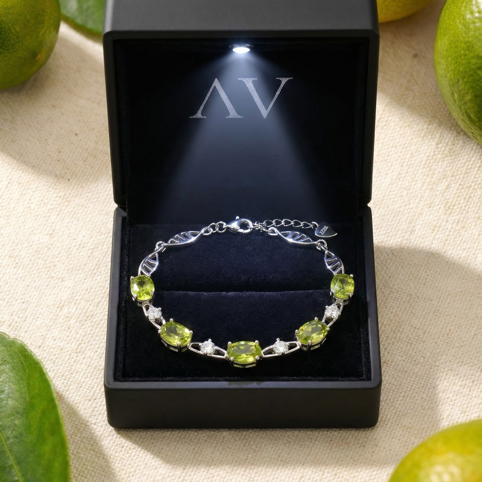 S925 sterling silver peridot station bracelet presented in a black lighted jewelry gift box.