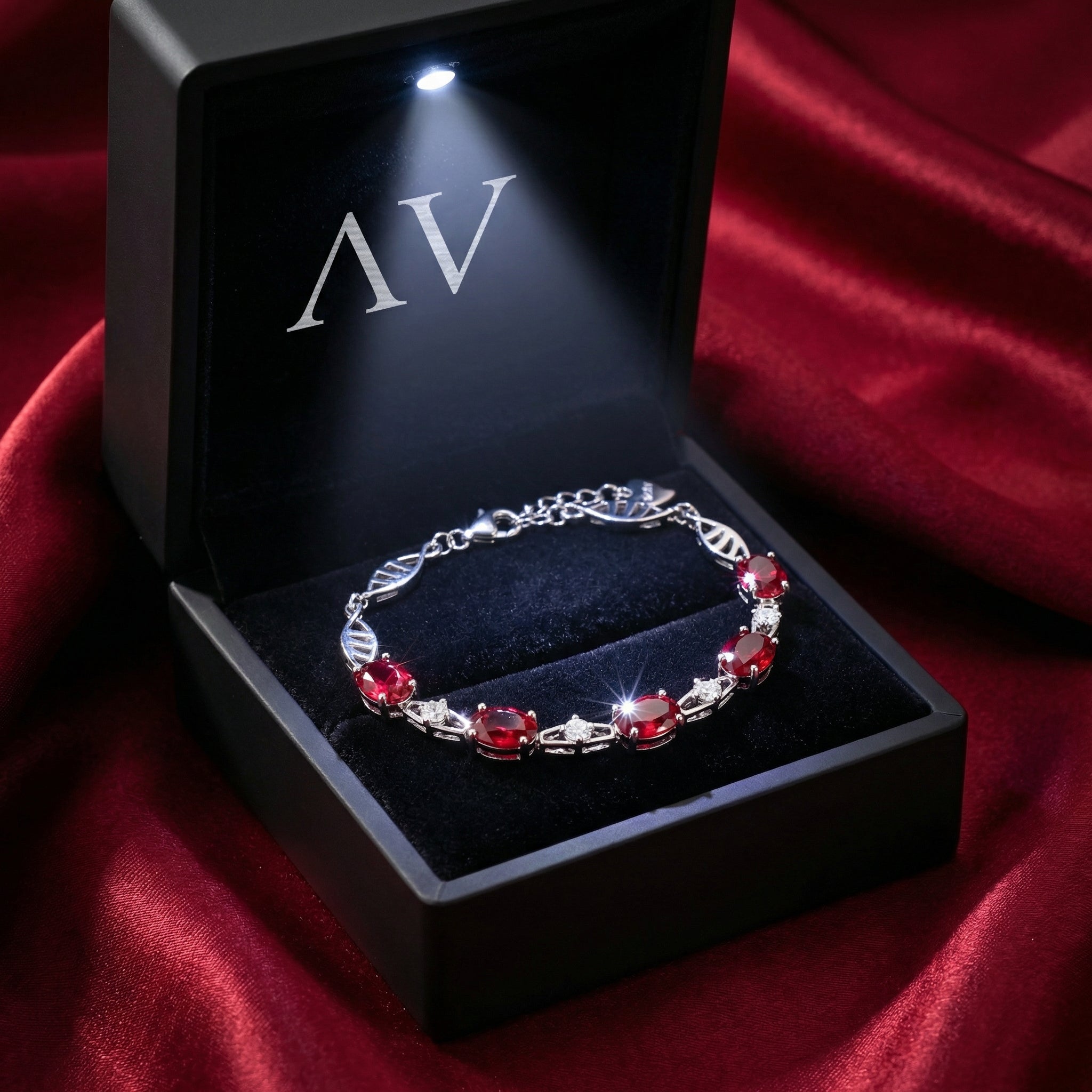 Sterling silver simulated ruby bracelet presented in a black LED-lit jewelry gift box.