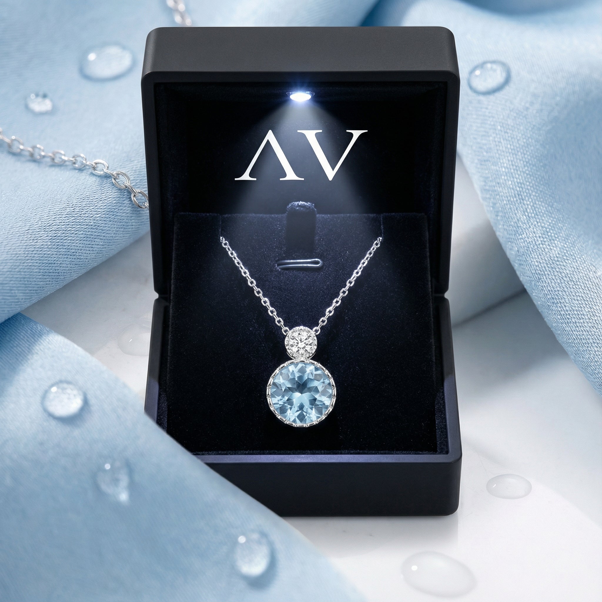 March birthstone simulated aquamarine necklace in a black LED-lighted jewelry box with AV logo.
