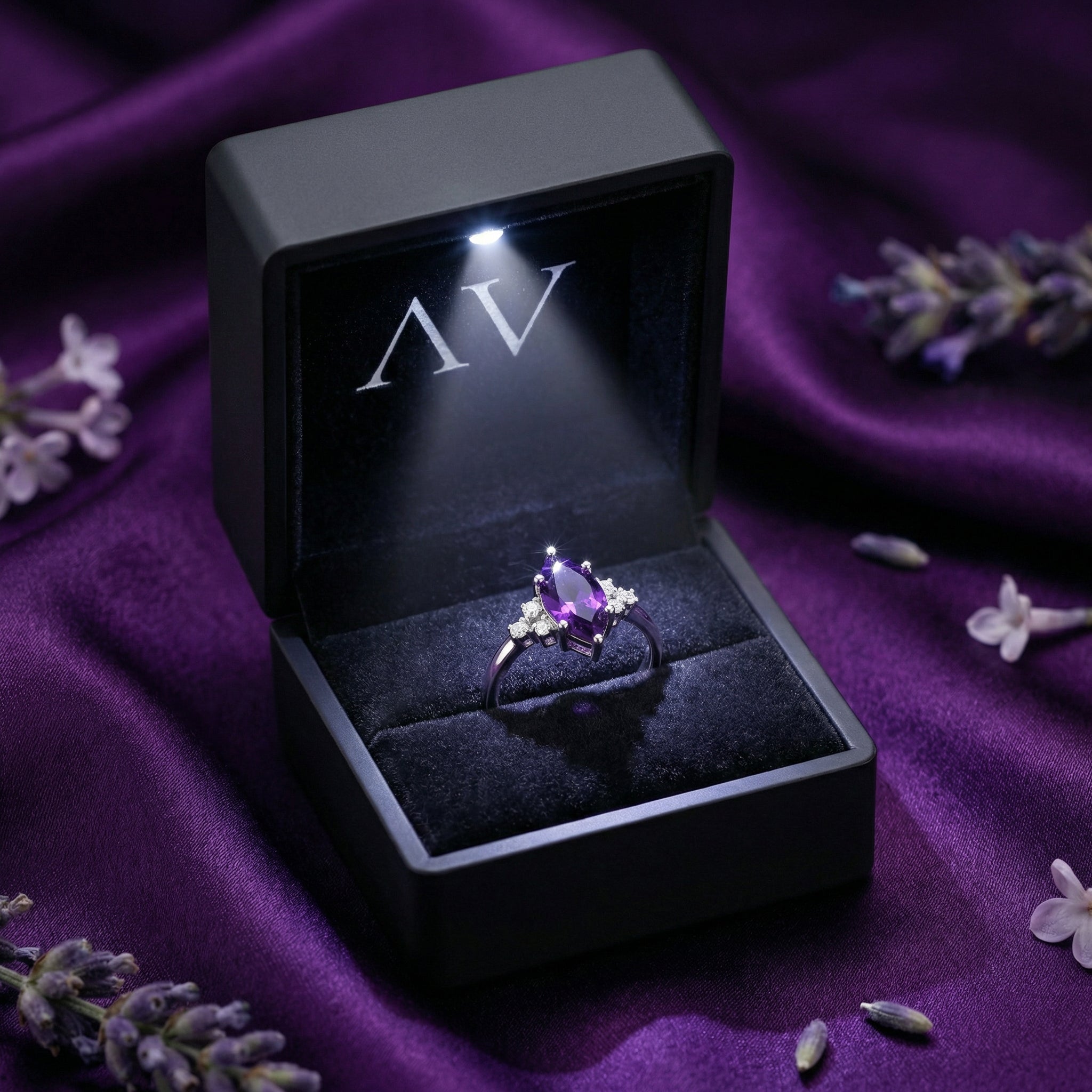 Marquesa cut amethyst sterling silver ring inside a black LED-lit gift box on purple silk.
