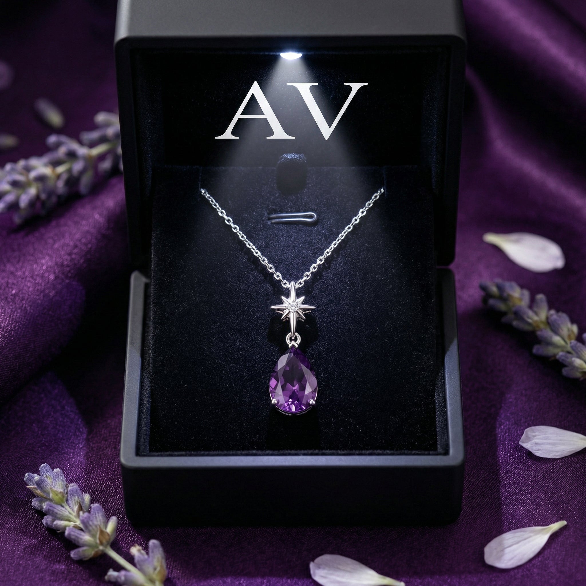 Isla pear cut amethyst necklace in sterling silver presented in a lighted black jewelry gift box.