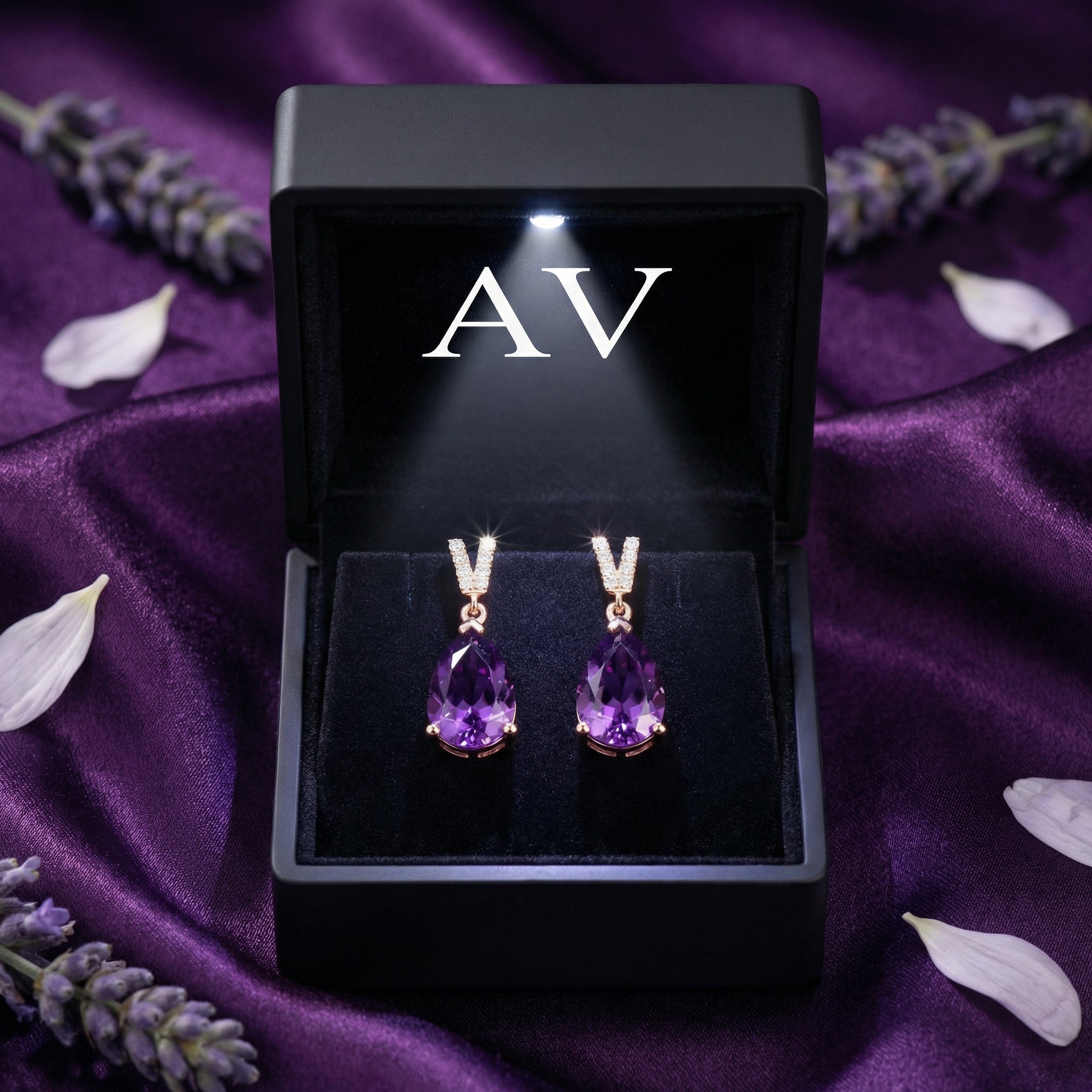 Pear cut amethyst drop earrings in 18k rose gold presented in a lighted black AV branded gift box.