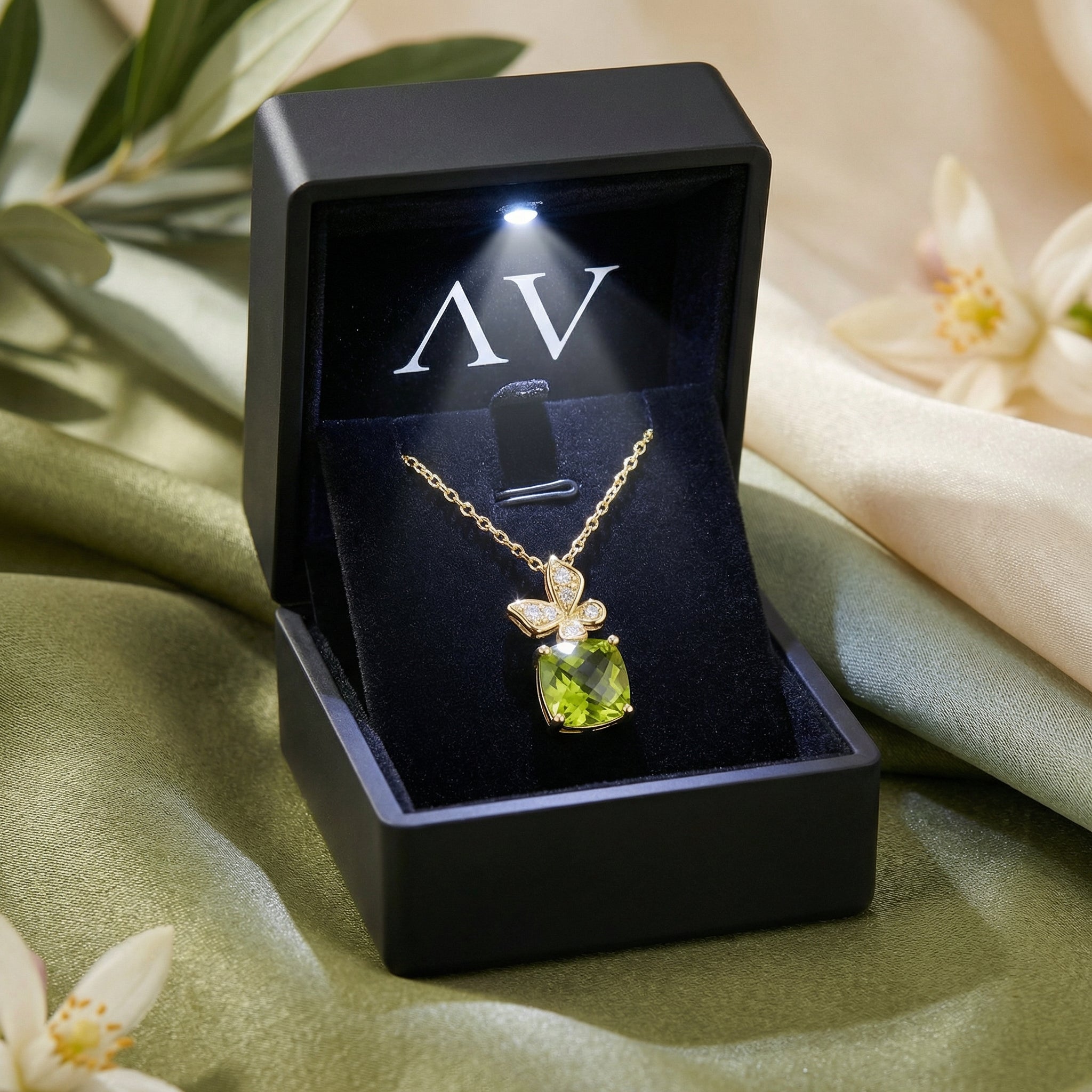 Cushion cut natural peridot necklace in 18K gold vermeil presented in a black lighted jewelry gift box.